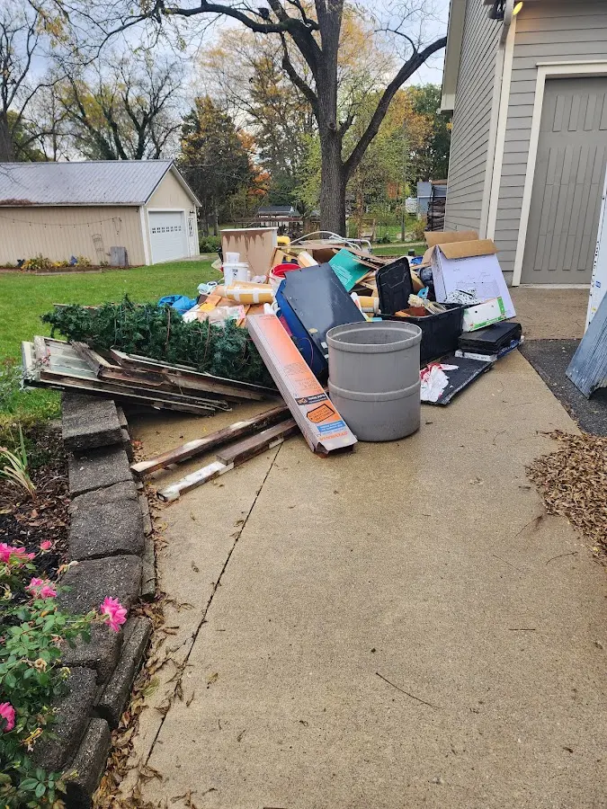 Dumpster being loaded with debris for 12 Yard Dumpster Rental in Millbury